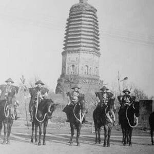 7 Chinese Gendarmes in peaked hats are mounted as skirmishes as cavalry in front of a temple. - Art Print