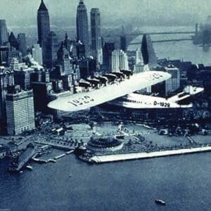 A Flying boat over Battery Park by Fairchild Aerial Surveys Inc. - Art Print