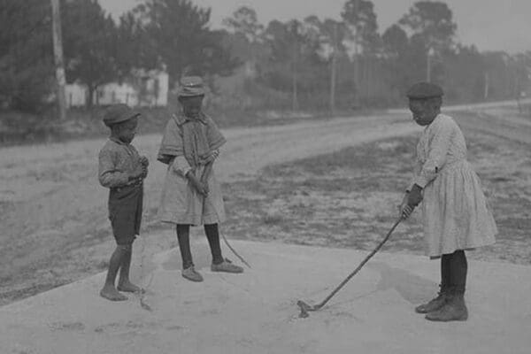 African American Children pretend to play golf on country road - Art Print