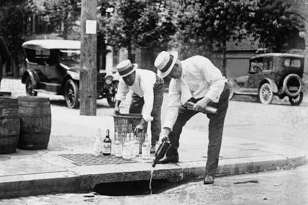 Agents Pouring liquor down a sewer on the Street - Art Print