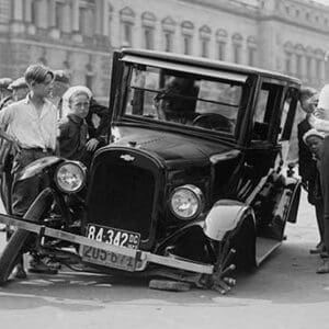 Automobile apparently hit the curb and cracked its front axle following which are attracted a group of onlookers - Art Print