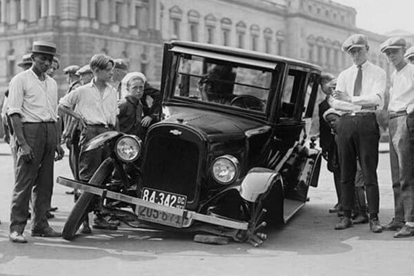 Automobile apparently hit the curb and cracked its front axle following which are attracted a group of onlookers - Art Print