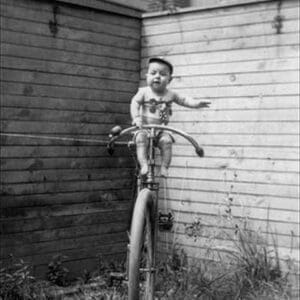 Baby on Unicycle by Jos N. Pearce - Art Print