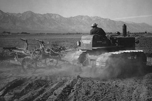 Benji Iguchi Driving Tractor in Field by Ansel Adams - Art Print