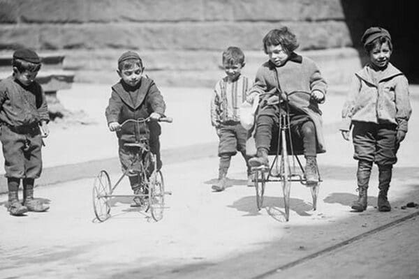 Children with Tricycles Playing in Manhattan Street - Art Print