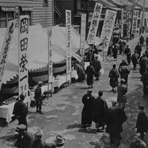 Election Day in Tokyo Japan shows a line of tables with signs in Kanji advertising political candidates - Art Print