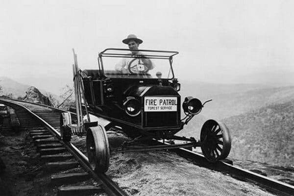 Fire Patrol Rides Steel wheeled car over Railroad Tracks - Art Print