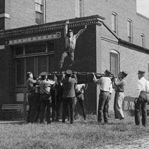 Firefighter Jumps into Net Held by Fellow Firemen - Art Print