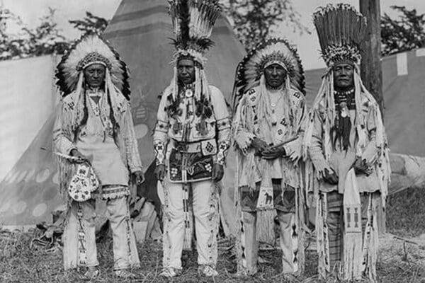 Four Native American Chiefs in Traditional Clothing and Feathered Bonnet - Art Print