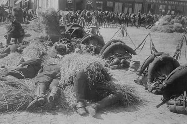 French soldiers in full pack bed down on straw after a long march - Art Print