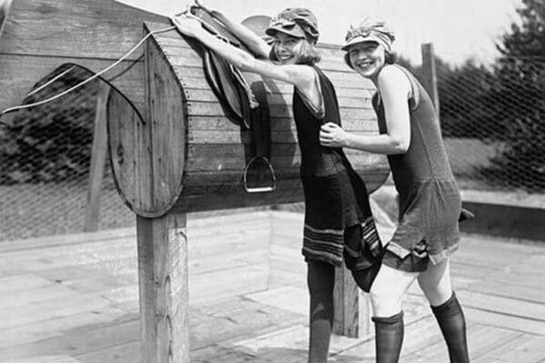 Girl is Helped by Friend to Mount a wooden Polo Dummy Horse - Art Print