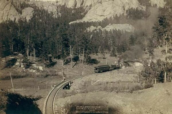 Horse Shoe Curve.' On Burlington and Missouri River Railway. Buckhorn Mountains in background by John C.H. Grabill - Art Print