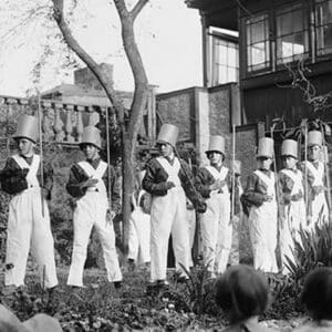 Line of Boys pose as Soldiers with inverted pails on their heads - Art Print