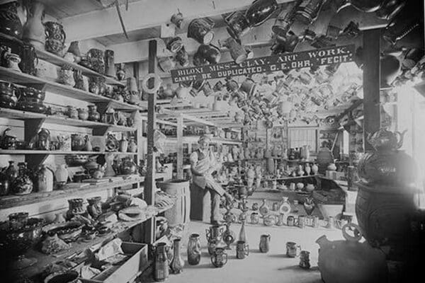 Owner sits in Retail Pottery Store waiting for Customers - Art Print