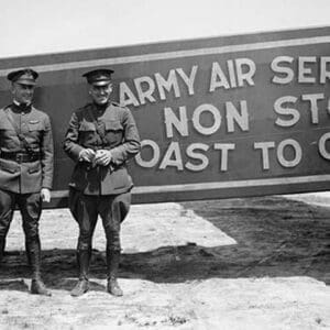 Pilots pose in front of a Plane that they fly coast to coast - Art Print