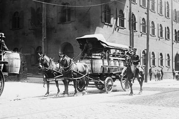 Police On Horseback Guard a Team Driven Wagon during car Strike - Art Print