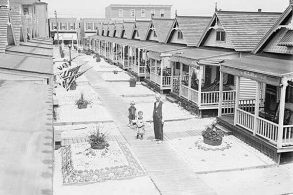 Porches and front lawns of row of bungalows