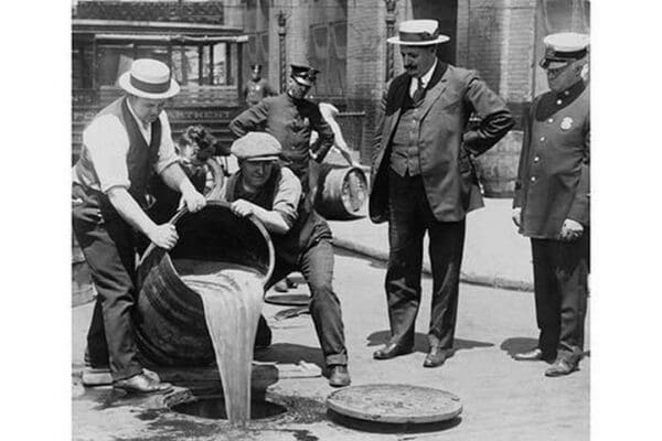 Pouring out illegal alcohol into a Sewer - Art Print