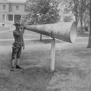 Soldier Plays his bugle into a huge megaphone at Fort Totten