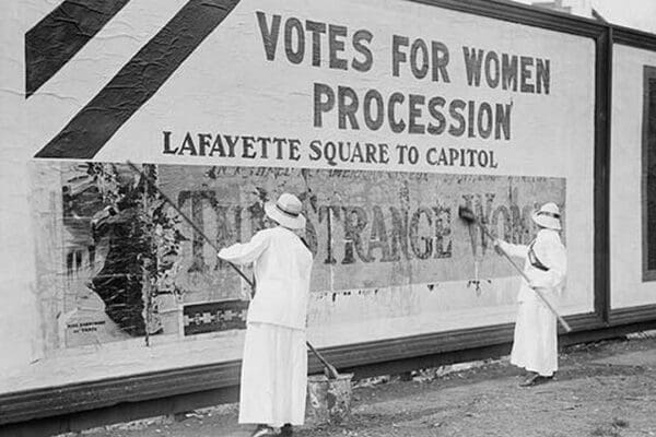 Suffragettes uses Long Brushes to Post a Billboard announcing a 'Votes' For Women' Parade - Art Print