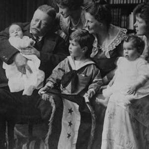 Teddy Roosevelt holds a baby in his arms in a Family Portrait - Art Print