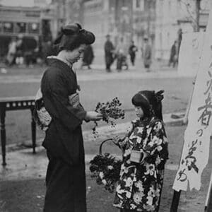 Toddler in front of Shop sign sells flowers to a kimono wearing young lady - Art Print