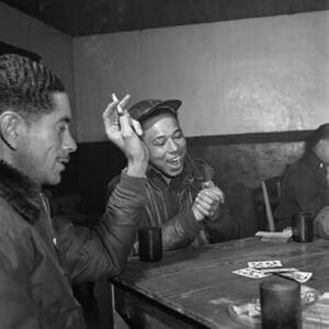 Tuskegee airmen playing cards in the officers' club in the evening - Art Print