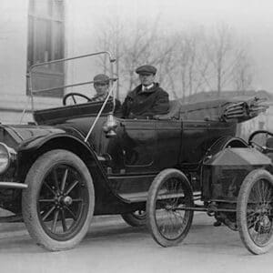 Two men in a large auto are side by two men in a Miniature Auto - Art Print