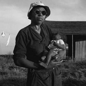 Wife and child of tractor driver by Dorothea Lange - Art Print