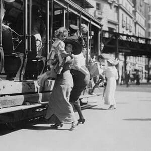 Woman lifts child off of an open sided Trolley Car on New York's Broadway - Art Print