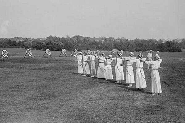 Woman's Archery Team Fires Arrows at a line of targets - Art Print